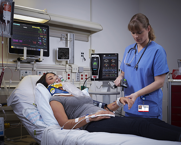 Clinician scanning patient barcode bracelet in the emergency room