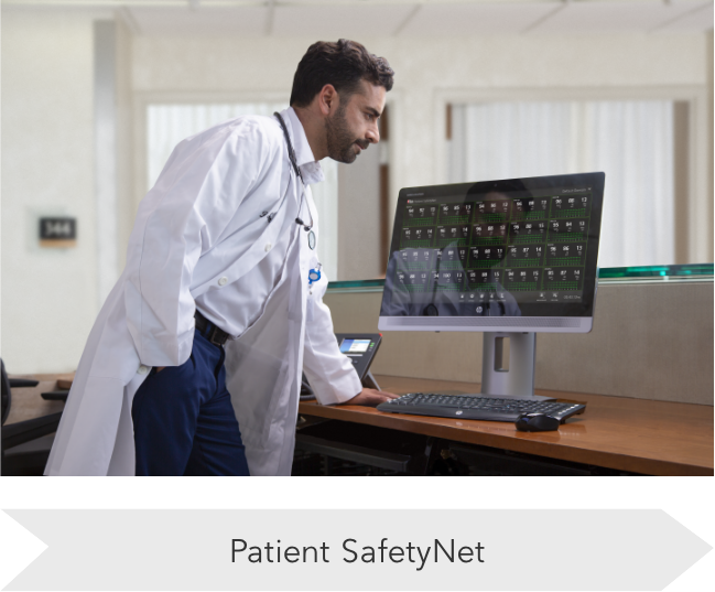 Clinician reviewing patient data on a desktop screen connected to Masimo monitoring systems, demonstrating centralized data management.